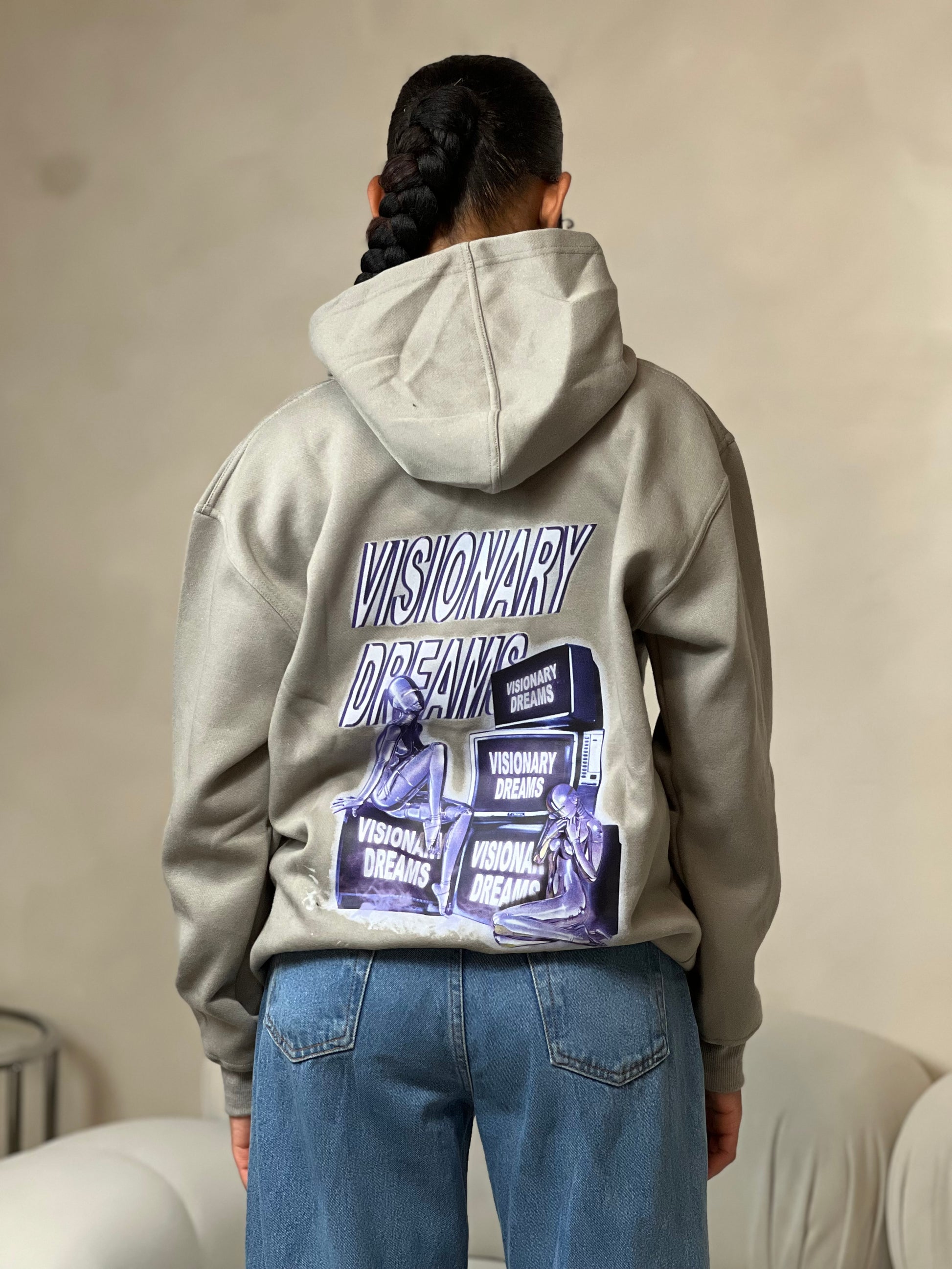 "Grey relaxed-fit pullover hoodie featuring a bold graphic design across the chest. Made from soft fleece material, it has an adjustable drawstring hood, ribbed cuffs, and a kangaroo pocket for added comfort and functionality. The oversized fit offers a casual, laid-back style, perfect for everyday wear."



