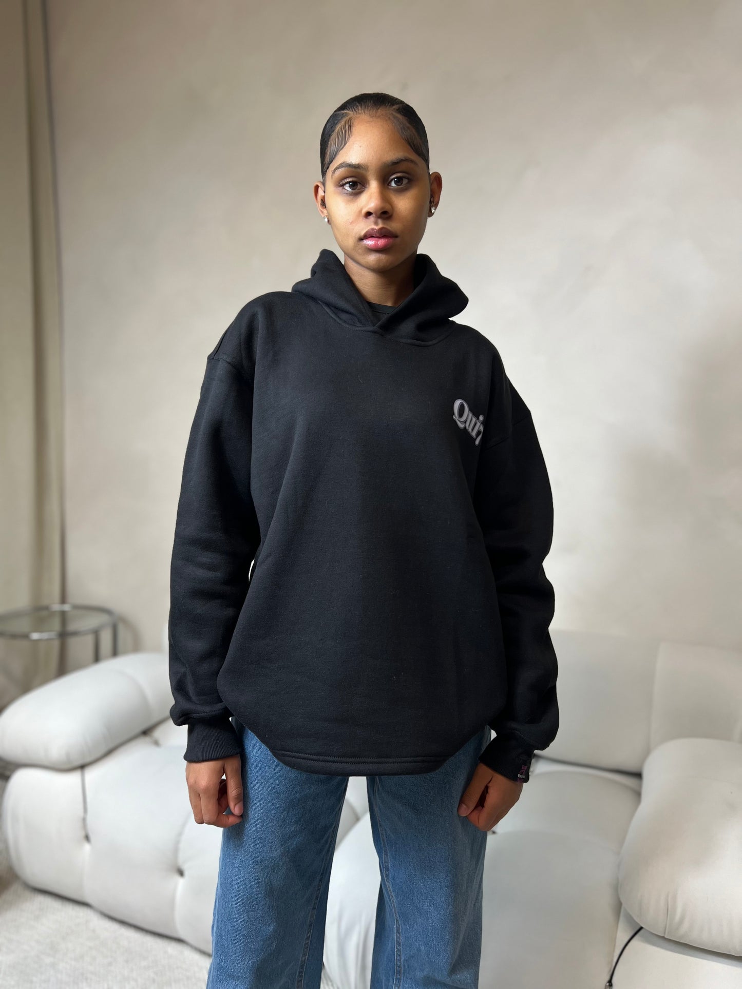 "Black graphic relaxed pullover hoodie featuring a bold, modern design on the front. The hoodie has a comfortable, oversized fit with a spacious hood, ribbed cuffs, and a soft interior, perfect for casual wear."