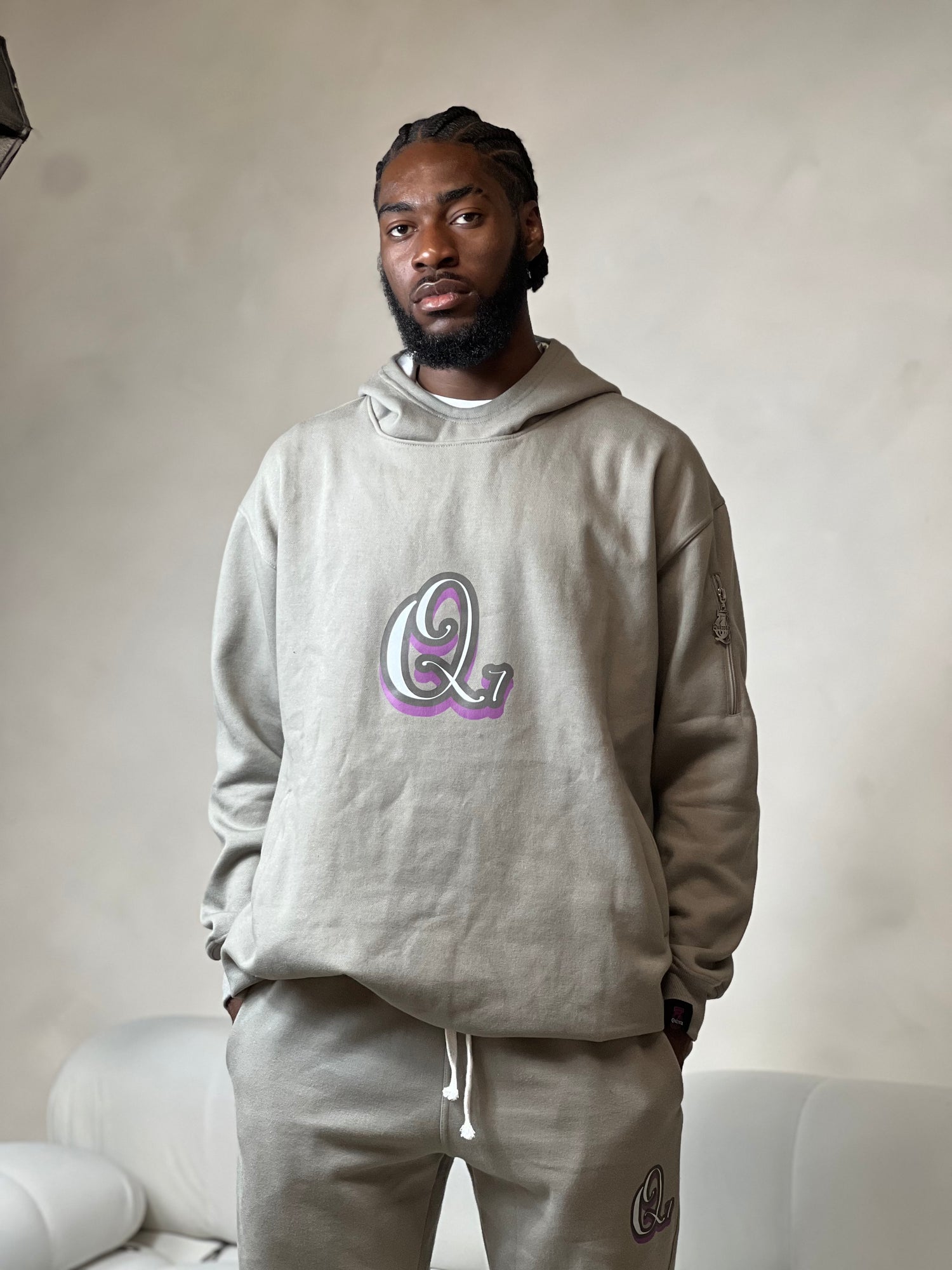 "Grey relaxed-fit hoodie made from soft fleece fabric, featuring an embroidered signature logo on the chest. The hoodie has an adjustable drawstring hood, ribbed cuffs, and a comfortable, oversized silhouette. Perfect for casual, everyday wear or layering during colder weather."



