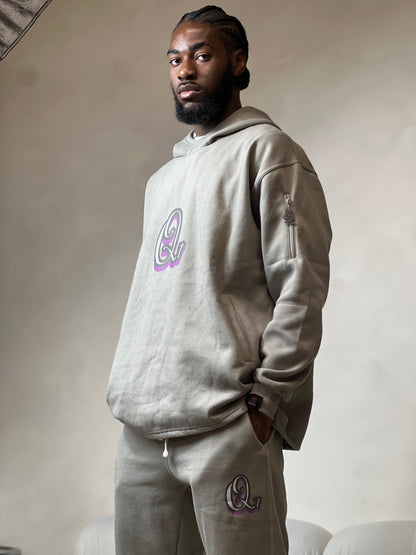 "Grey relaxed-fit hoodie made from soft fleece fabric, featuring an embroidered signature logo on the chest. The hoodie has an adjustable drawstring hood, ribbed cuffs, and a comfortable, oversized silhouette. Perfect for casual, everyday wear or layering during colder weather."



