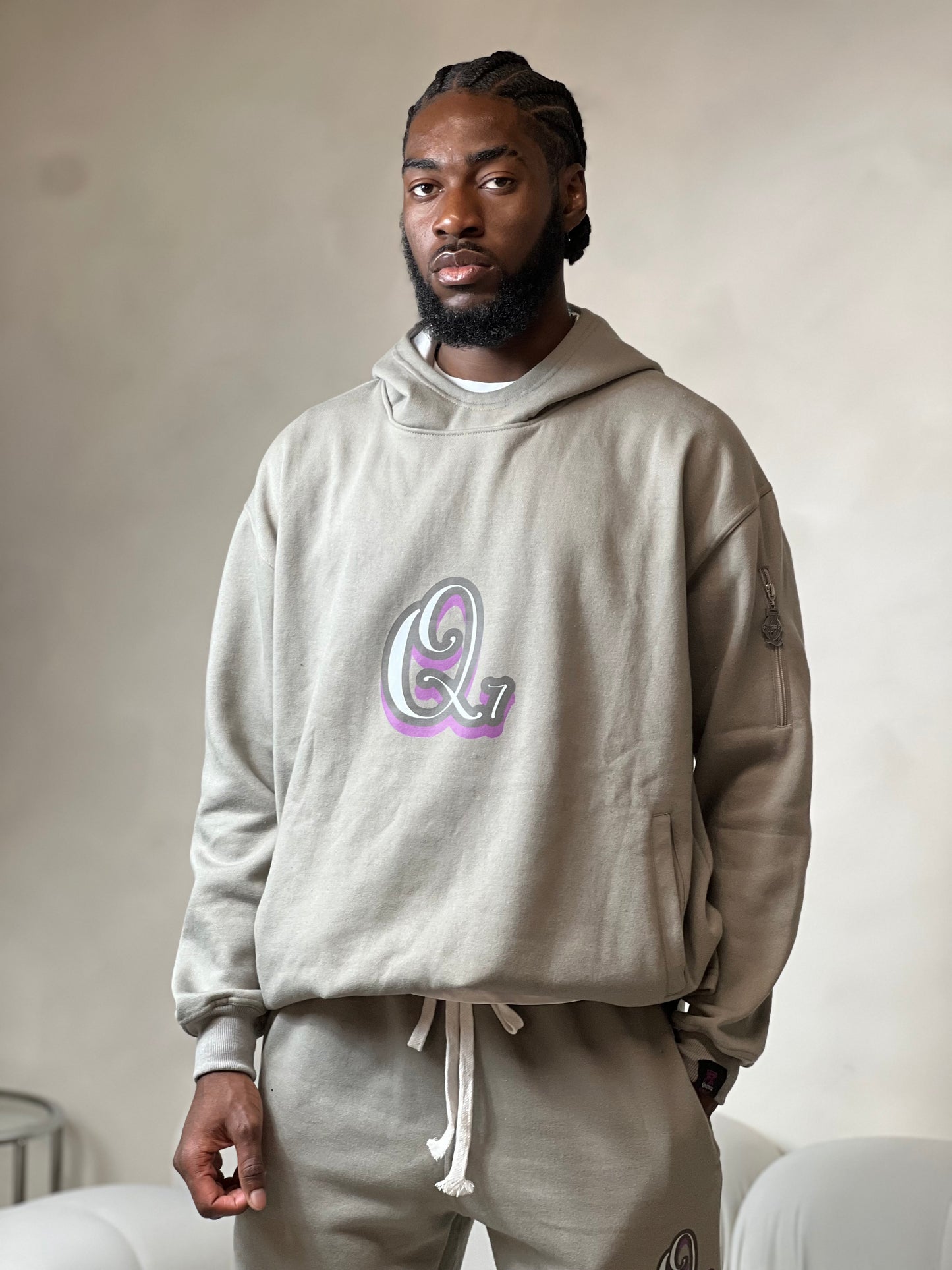 "Grey relaxed-fit hoodie made from soft fleece fabric, featuring an embroidered signature logo on the chest. The hoodie has an adjustable drawstring hood, ribbed cuffs, and a comfortable, oversized silhouette. Perfect for casual, everyday wear or layering during colder weather."



