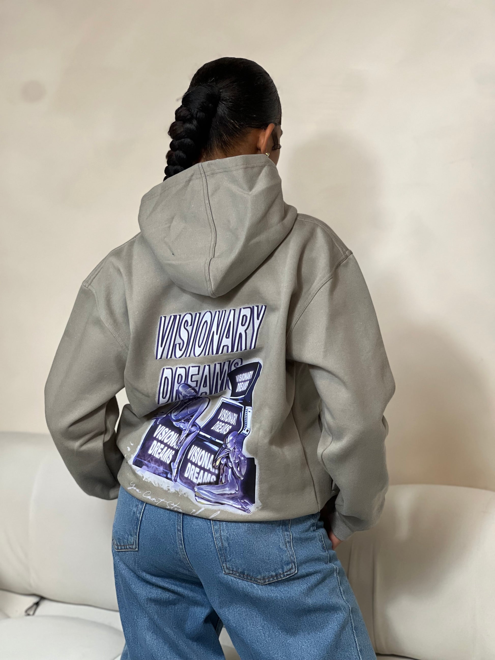 "Grey relaxed-fit pullover hoodie featuring a bold graphic design across the chest. Made from soft fleece material, it has an adjustable drawstring hood, ribbed cuffs, and a kangaroo pocket for added comfort and functionality. The oversized fit offers a casual, laid-back style, perfect for everyday wear."



