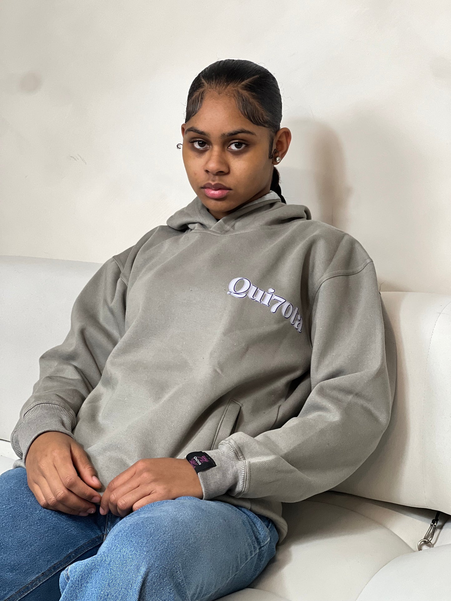 "Grey relaxed-fit pullover hoodie featuring a bold graphic design across the chest. Made from soft fleece material, it has an adjustable drawstring hood, ribbed cuffs, and a kangaroo pocket for added comfort and functionality. The oversized fit offers a casual, laid-back style, perfect for everyday wear."



